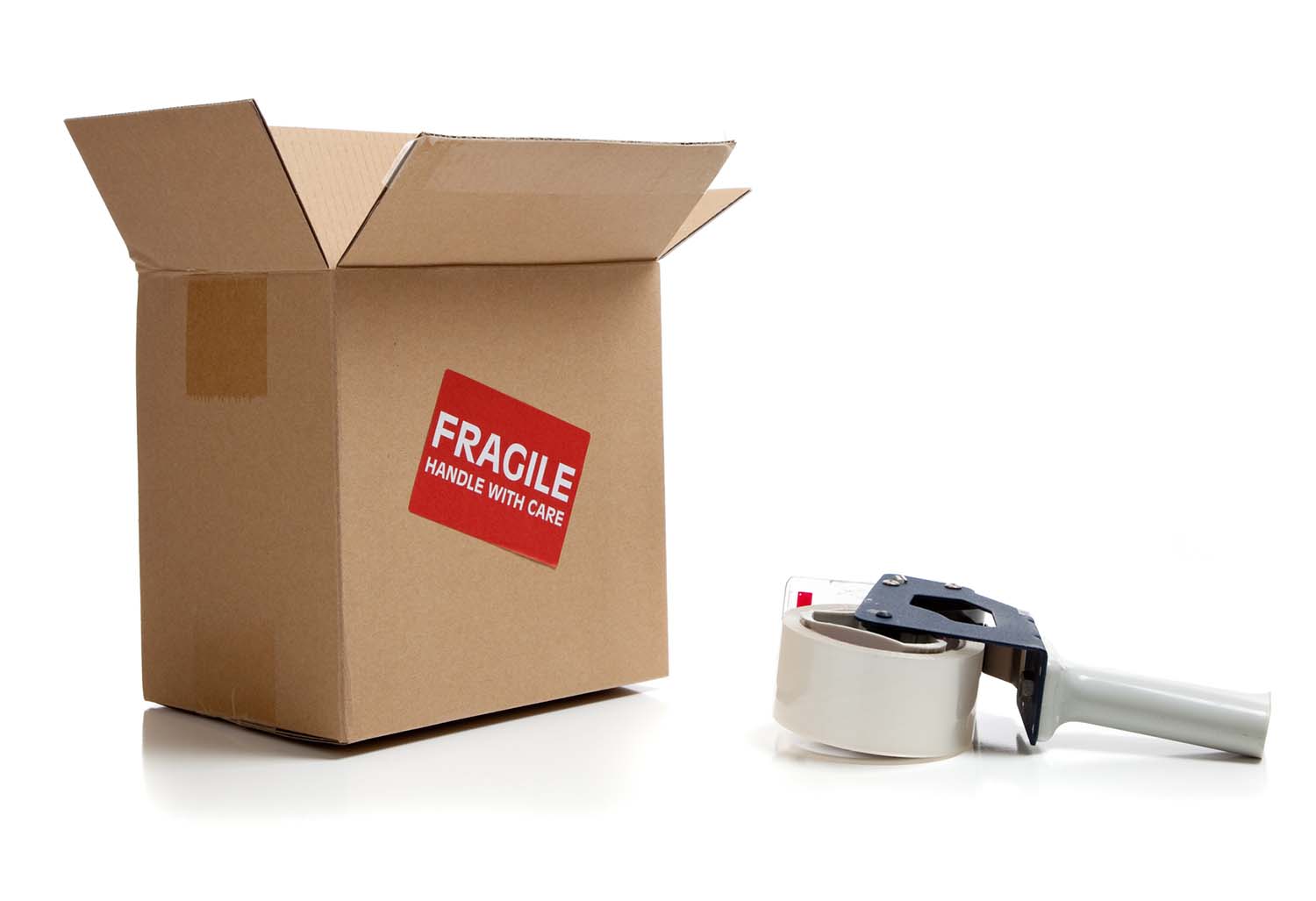 Cardboard shipping box with a tape gun on a white background